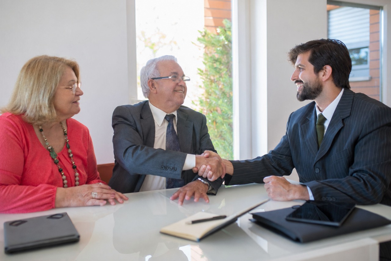 Shaking hands with a mediator during an informal dispute resolution meeting.